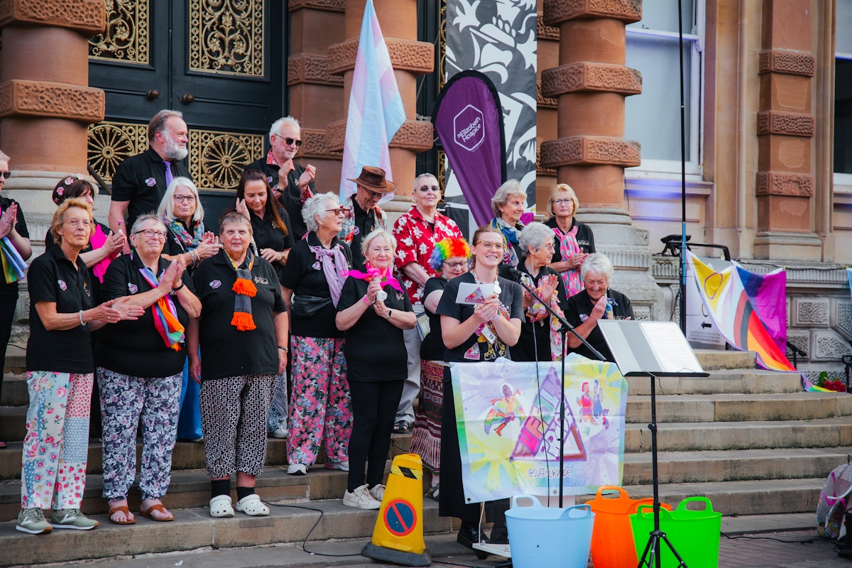 Person giving a speech on the steps of a town hall